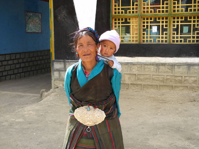 The Western Tibet yak riding champion of 2006 letting grandmom wear his championship buckle.